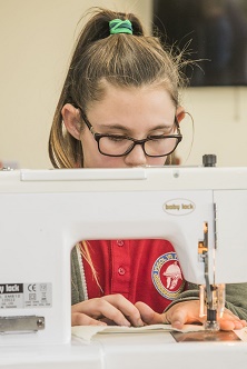 Artist Cefyn Burgess with school children from Ysgol Hendre working on the Patagonia project with residents at Bryn Seiont, Caernarfon. Pupil Mia Gardner, 10