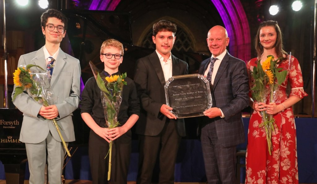 Mario Kreft MBE presents the trophy to the winner Iván Cherednichenko Carrillo  joined by the three other contestants Llewelyn Blezard-Greenwell, Ethan Pawley who came second and Leisa Mair Lloyd-Edwards