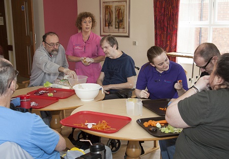 Pendine Park's Enrichment coordinator Elaine Lee has started a cooking club for residents to enjoy. Pictured: Elaine and the residents work on a vegetable soup