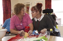 Pendine Park's Enrichment coordinator Elaine Lee has started a cooking club for residents to enjoy. Pictured: Sian Walley prepares the onion and has a giggle with Elaine